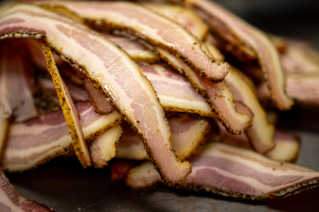 Thick-cut Bourgeois Cajun Smoked Bacon, perfectly seasoned with bold Cajun spices and slow-smoked over natural hardwoods for a rich, smoky flavor. A Southern favorite for breakfast, sandwiches, or cooking