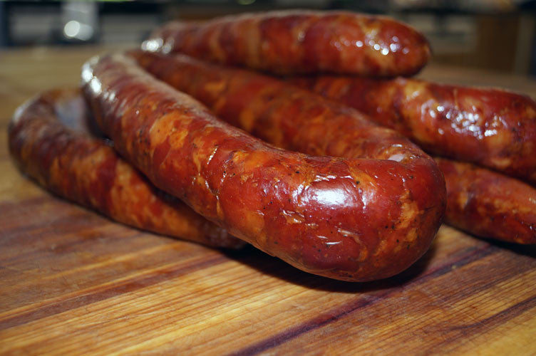 Cajun Smoked Andouille Sausage from Bourgeois Meat Market, a traditional Louisiana sausage slow-smoked over wood, perfect for gumbo and jambalaya.