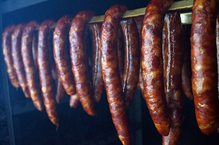 Cajun Smoked Andouille Sausage from Bourgeois Meat Market, a traditional Louisiana sausage slow-smoked over wood, perfect for gumbo and jambalaya.