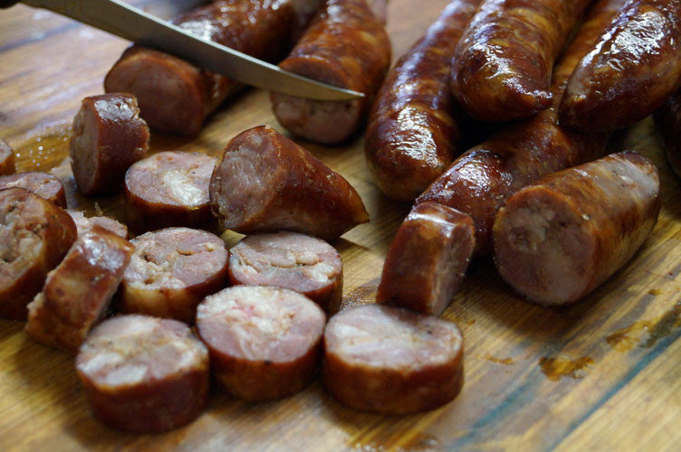 Cajun Smoked Andouille Sausage from Bourgeois Meat Market, a traditional Louisiana sausage slow-smoked over wood, perfect for gumbo and jambalaya.