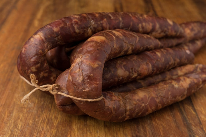 Cajun Smoked Andouille Sausage from Bourgeois Meat Market, a traditional Louisiana sausage slow-smoked over wood, perfect for gumbo and jambalaya.