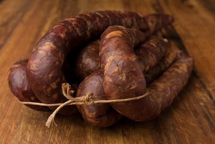 Cajun Smoked Andouille Sausage from Bourgeois Meat Market, a traditional Louisiana sausage slow-smoked over wood, perfect for gumbo and jambalaya.