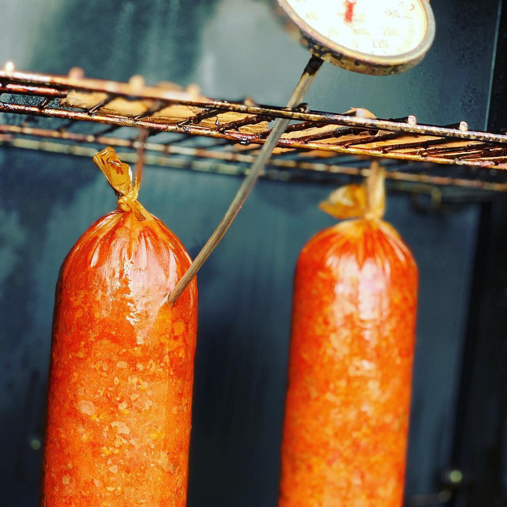 Handcrafted Cajun wood-smoked summer sausage from Bourgeois Meat Market—bold, savory flavor perfect for charcuterie boards, road trips, and protein-packed snacks.